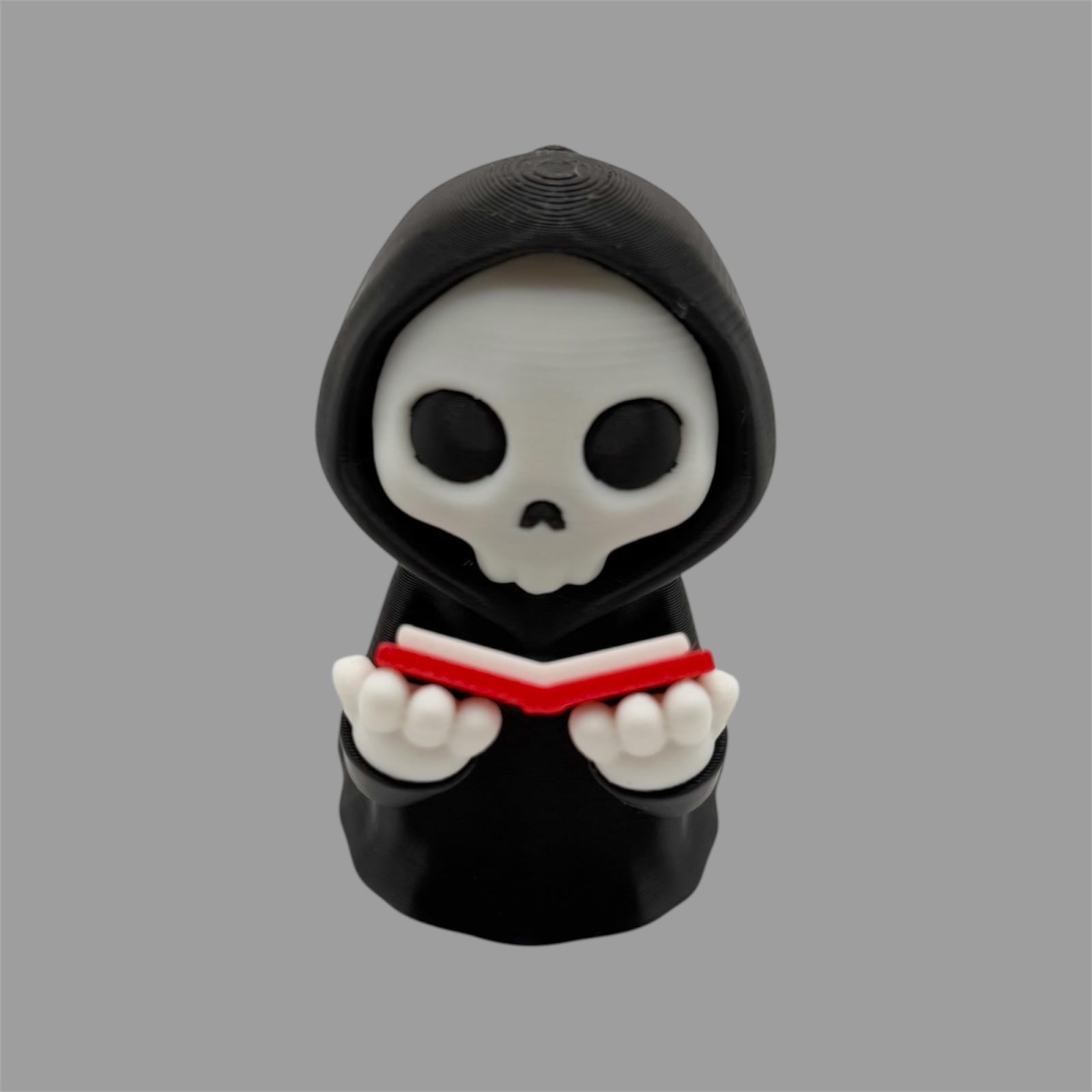 Grim Reaper Reading a Book